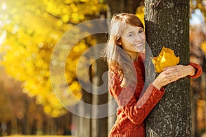 Beautiful happy young woman in the autumn park. Joyful woman is