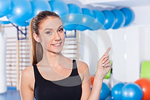 Beautiful happy young woman in gym. Gym shot. Crossfit hall. She