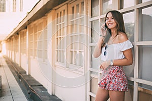 Beautiful happy young woman on the mobile phone