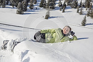 Beautiful happy young woman playing in the snow. Winter activity