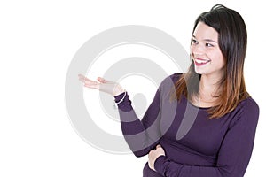 Beautiful happy young woman presenting a blank advertising in copy space