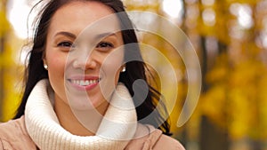 Beautiful happy young woman smiling in autumn park