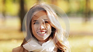 Beautiful happy young woman smiling in autumn park