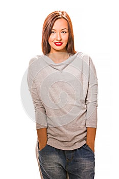 Beautiful happy young woman standing with hands in pockets.