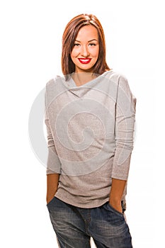 Beautiful happy young woman standing with hands in pockets.