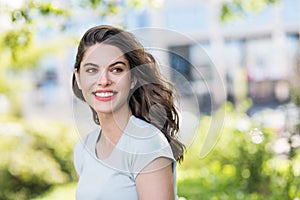 Beautiful happy young woman summer portrait. Pretty model girl with perfect fresh clean skin smiling  outdoors