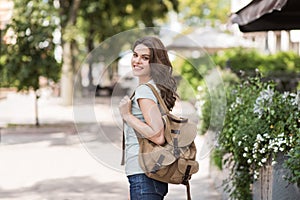 Beautiful happy young woman summer portrait. Pretty smiling model girl walking in a city