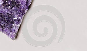 Beautiful healing semiprecious violet amethyst gemstone on white background macro close up with copy space