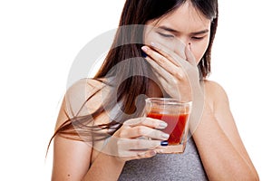 Beautiful healthy Asian girl hate tomato juice.