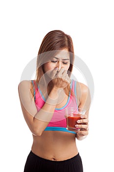 Beautiful healthy Asian girl hate tomato juice