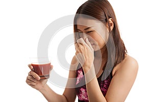 Beautiful healthy Asian girl hate tomato juice.