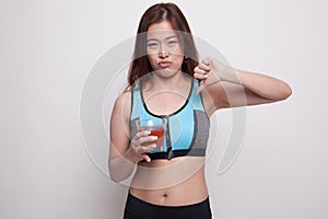 Beautiful healthy Asian girl hate tomato juice thumbs down.