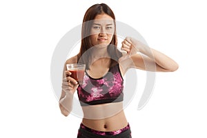 Beautiful healthy Asian girl hate tomato juice thumbs down.