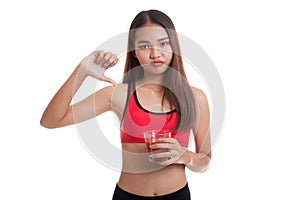 Beautiful healthy Asian girl hate tomato juice thumbs down.