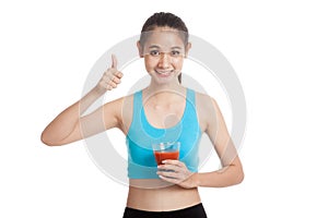 Beautiful healthy Asian girl thumbs up with tomato juice