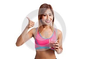 Beautiful healthy Asian girl thumbs up with tomato juice