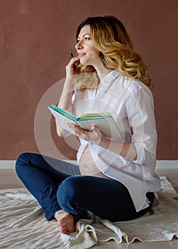 Beautiful healthy pregnant woman sitting