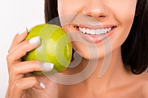Beautiful healthy smile. Girl smiling with green apple