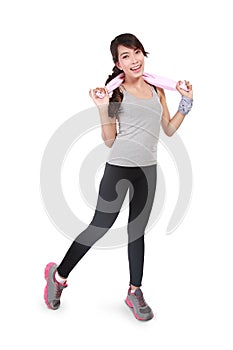 Beautiful healthy sportswoman wearing sportswear posing with towel
