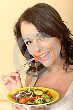 Beautiful Healthy Young Woman Eating a Fresh Garden Salad