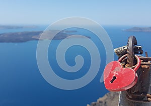 Beautiful heart Lock hanging on the railing of the bridge against the blue sky and the sea