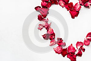 Beautiful heart of red rose petals isolated on white