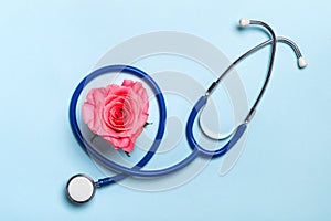 Beautiful heart rose and stethoscope on blue background. Thank you doctor and nurse concept