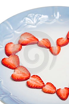 Beautiful heart symbol from chopped red juicy strawberry