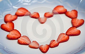 Beautiful heart symbol from chopped red juicy strawberry