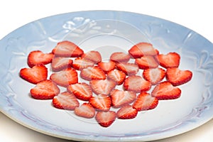 Beautiful heart symbol from chopped red juicy strawberry