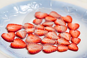 Beautiful heart symbol from chopped red juicy strawberry