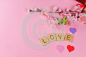 Beautiful hearts of red letters with love on a pink background