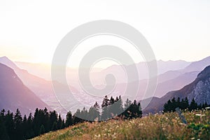 Beautiful high angle shot of hills under the brights sky and silhouettes of trees