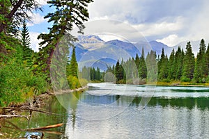 Beautiful high mountains of the Canadian Rockies reflecting in an alpine lake along the Icefields Parkway between Banff and Jasper