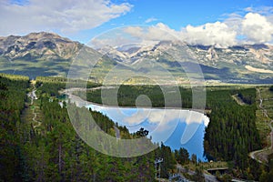 Beautiful high mountains of the Canadian Rockies reflecting in an alpine lake along the Icefields Parkway between Banff and Jasper