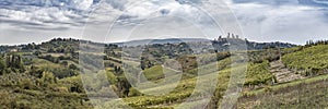 Beautiful hills with vineyards in Tuscany with town San Gimignano in Italy