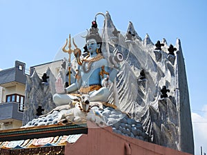 Beautiful hindu god Lord Shiva Statue at the top of the temple with snow background