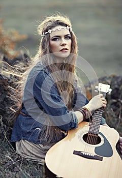 Beautiful hippie girl with guitar