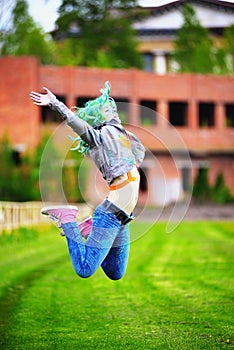 Beautiful hipster alternative young woman with green hair jump