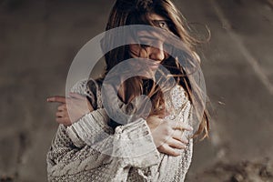 Beautiful hipster woman in boho indie clothes, posing in winter