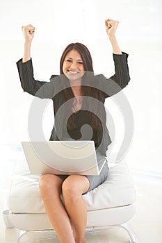 Beautiful hispanic business female with laptop excited