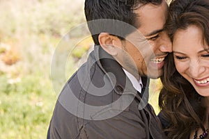 Beautiful Hispanic couple laughing and smiling.