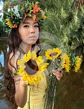 beautiful hispanic indigenous model wearing a yellow dress flower crown sunflowers flowers nature trees