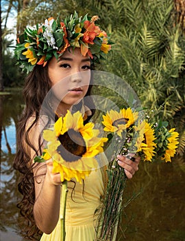 beautiful hispanic indigenous model wearing a yellow dress flower crown sunflowers flowers nature trees