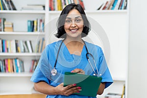 Beautiful hispanic nurse wirh file of patient