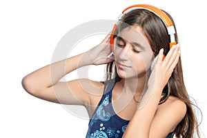 Beautiful hispanic teenage girl enjoying music on bright orange headphones