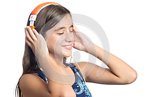 Beautiful hispanic teenage girl enjoying music on bright orange headphones