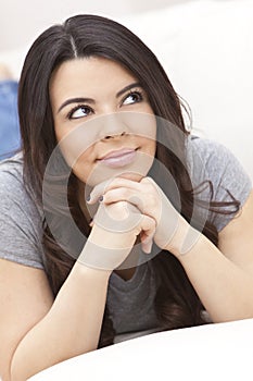 Beautiful Hispanic Woman on Sofa Smiling