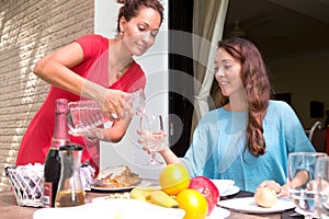 Beautiful hispanic women enjoying an outdoor home meal together