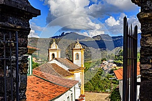 Beautiful historic church in the city of Ouro Preto seen between old stone portals